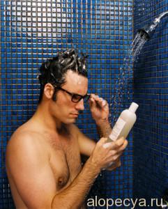 Man Reading Instructions on Shampoo Bottle